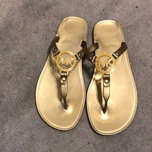 Michael Kors gold flip flops